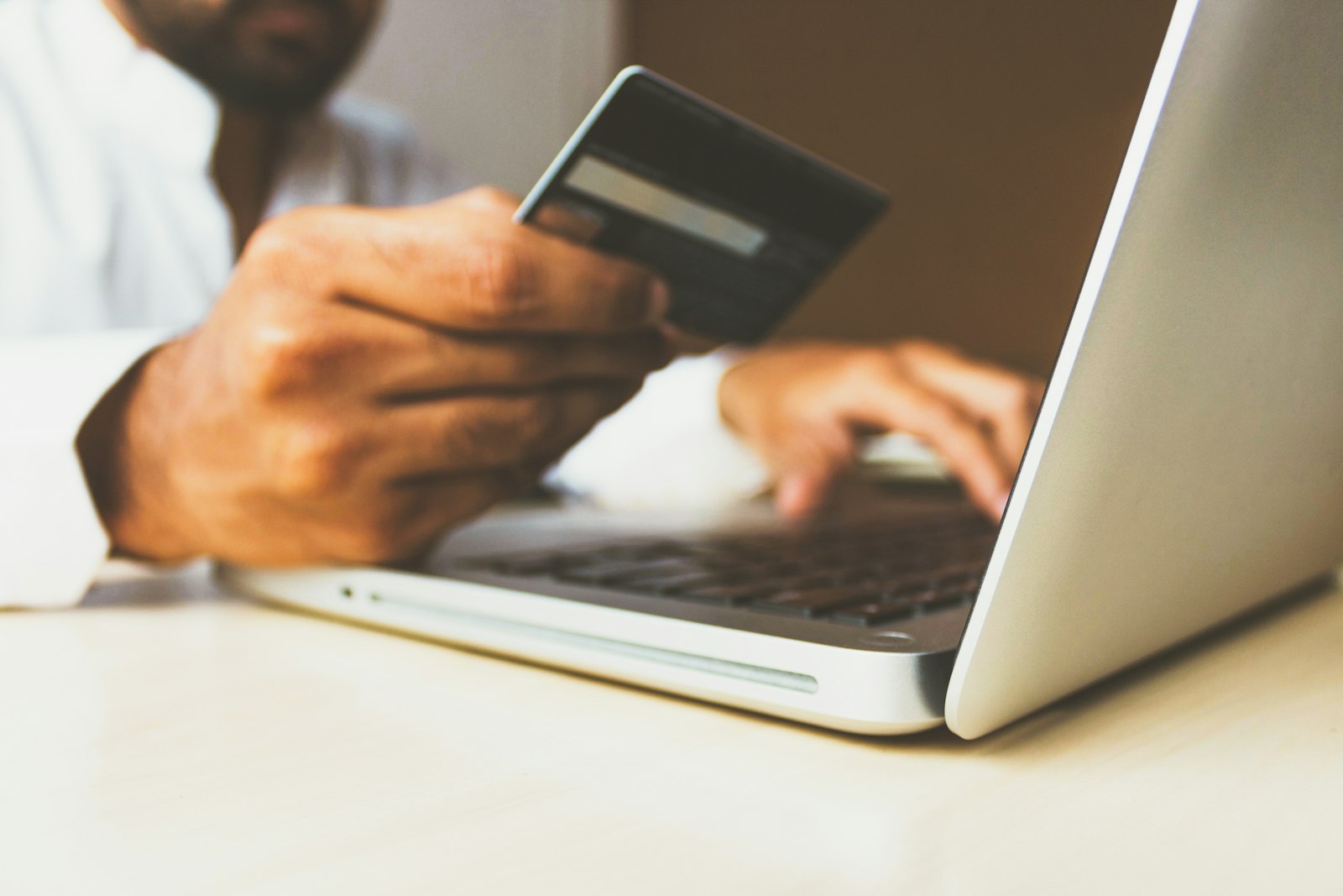 A credit card and laptop — Steam now requires card-based age verification in the UK