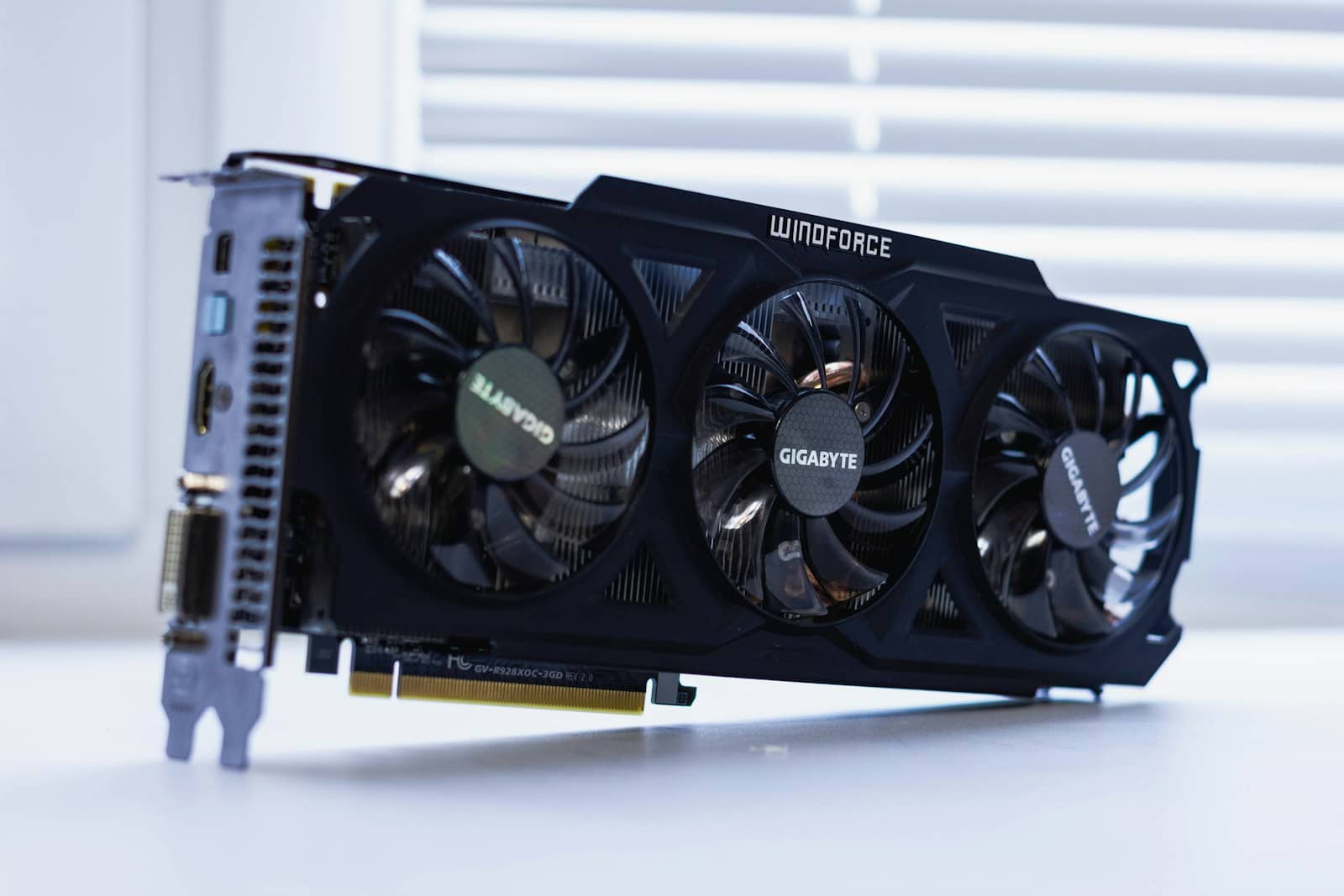 A multi-fan graphics card on a windowsill
