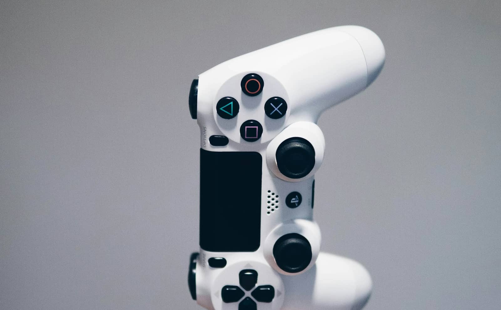 A white game controller on a light background