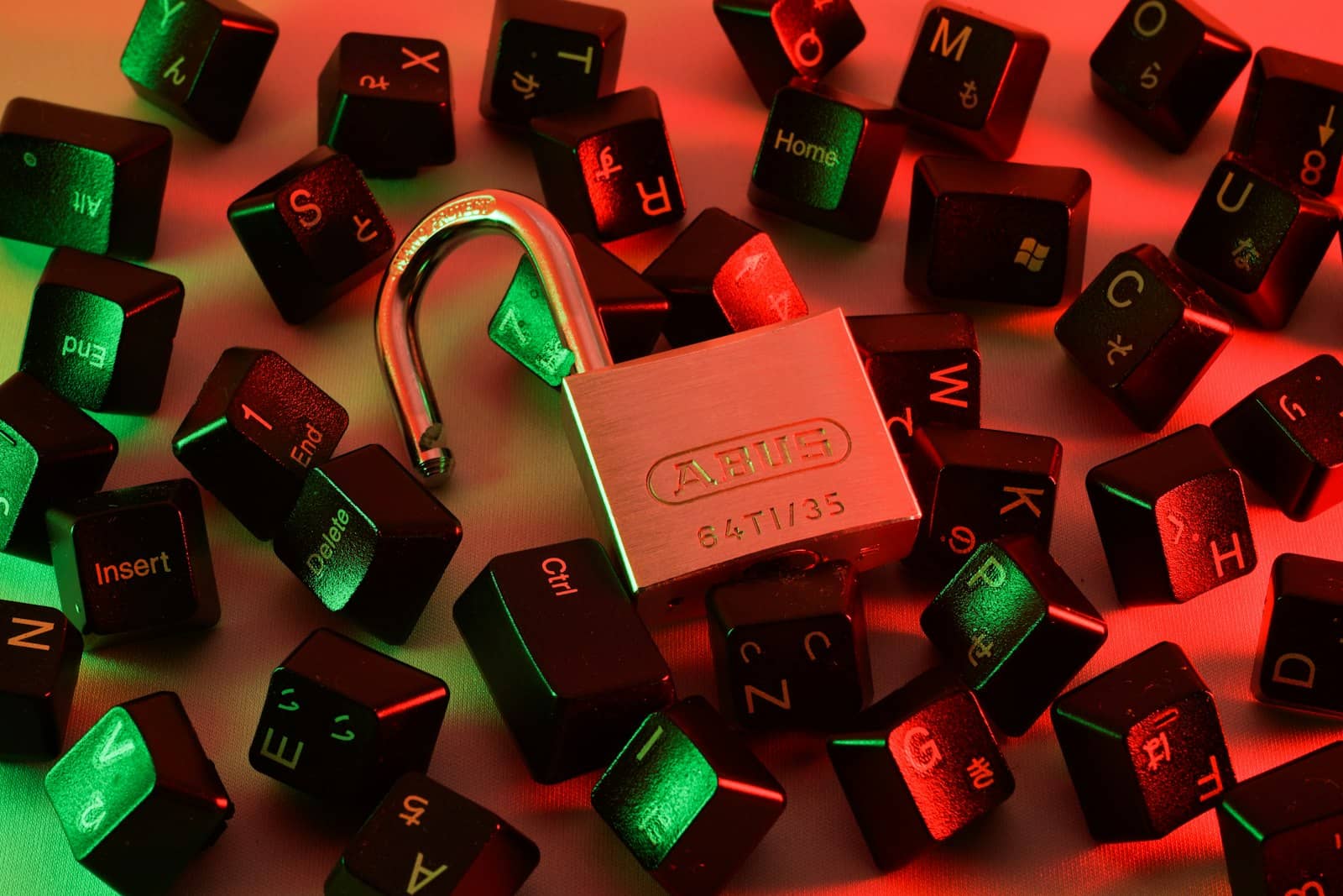 An open padlock among scattered keyboard keys