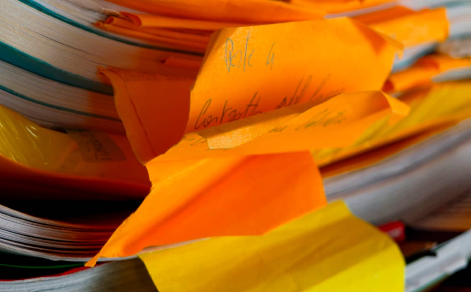 A stack of documents and papers with sticky tabs