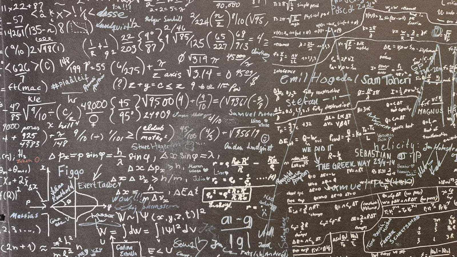 Mathematical equations written on a dark surface