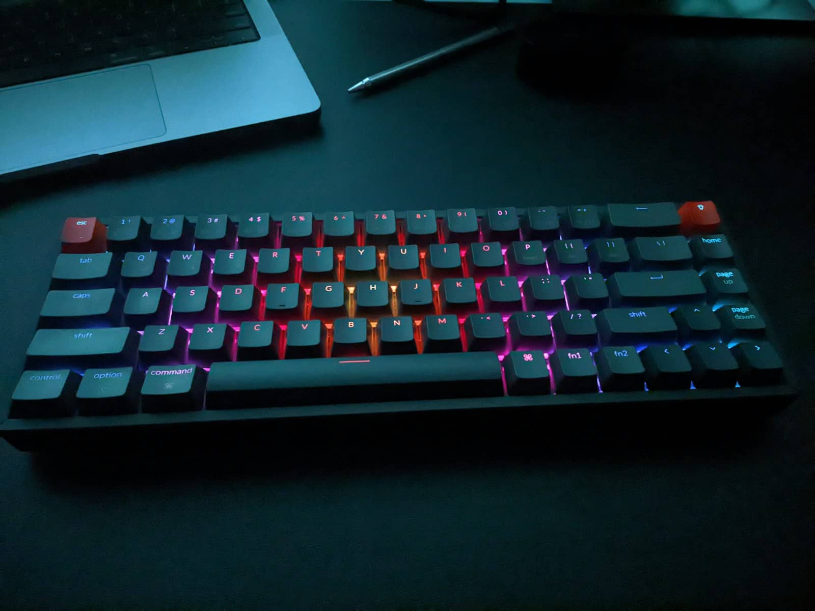 A backlit gaming keyboard in a dark room
