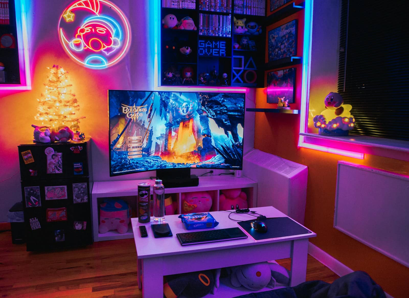 A gaming room with a monitor and neon lighting