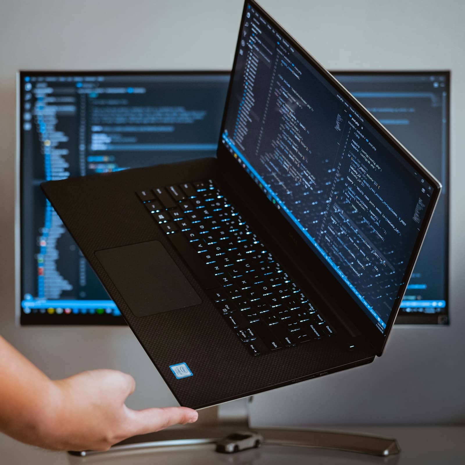 A developer working at a laptop with code
