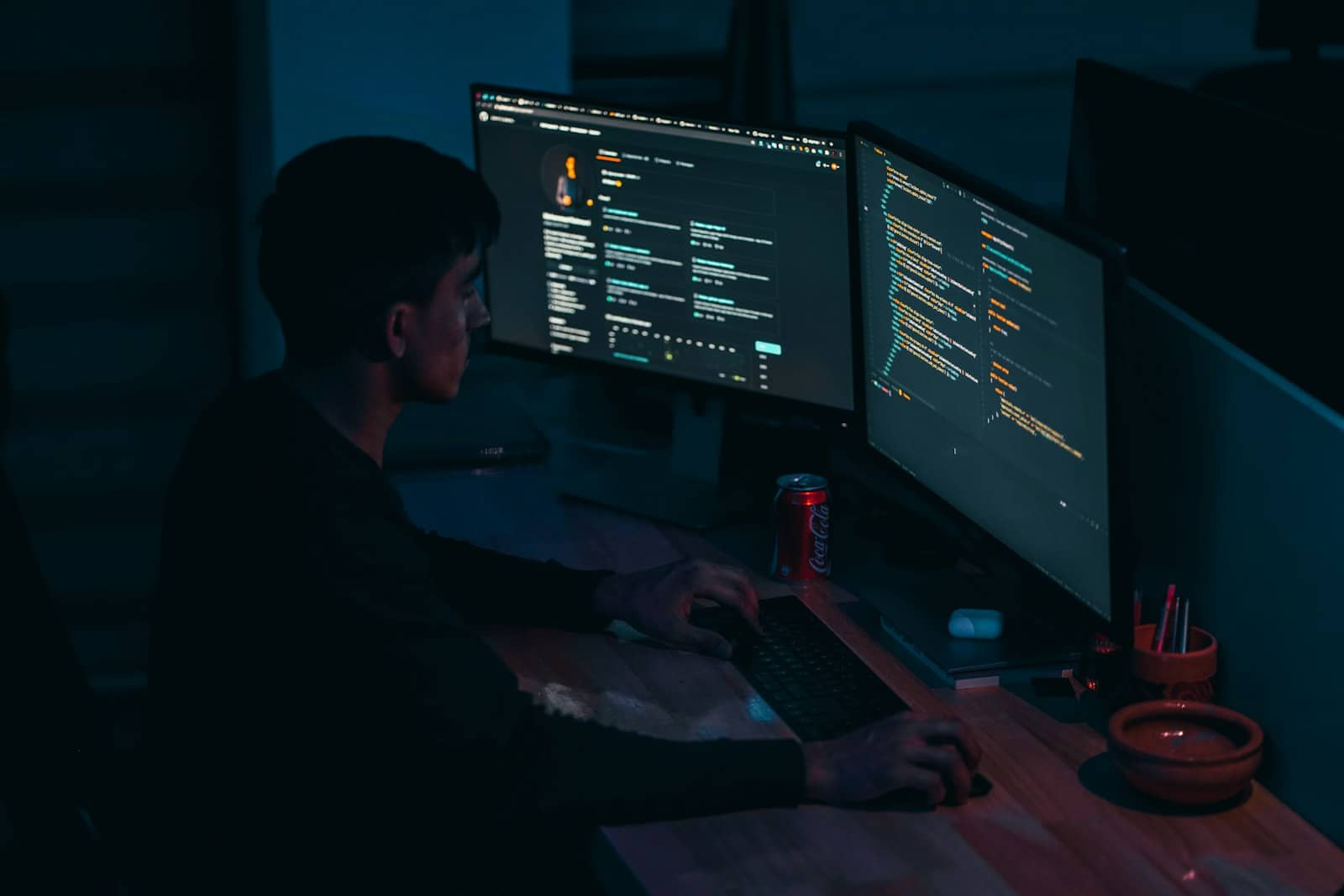 A programmer typing code on a keyboard