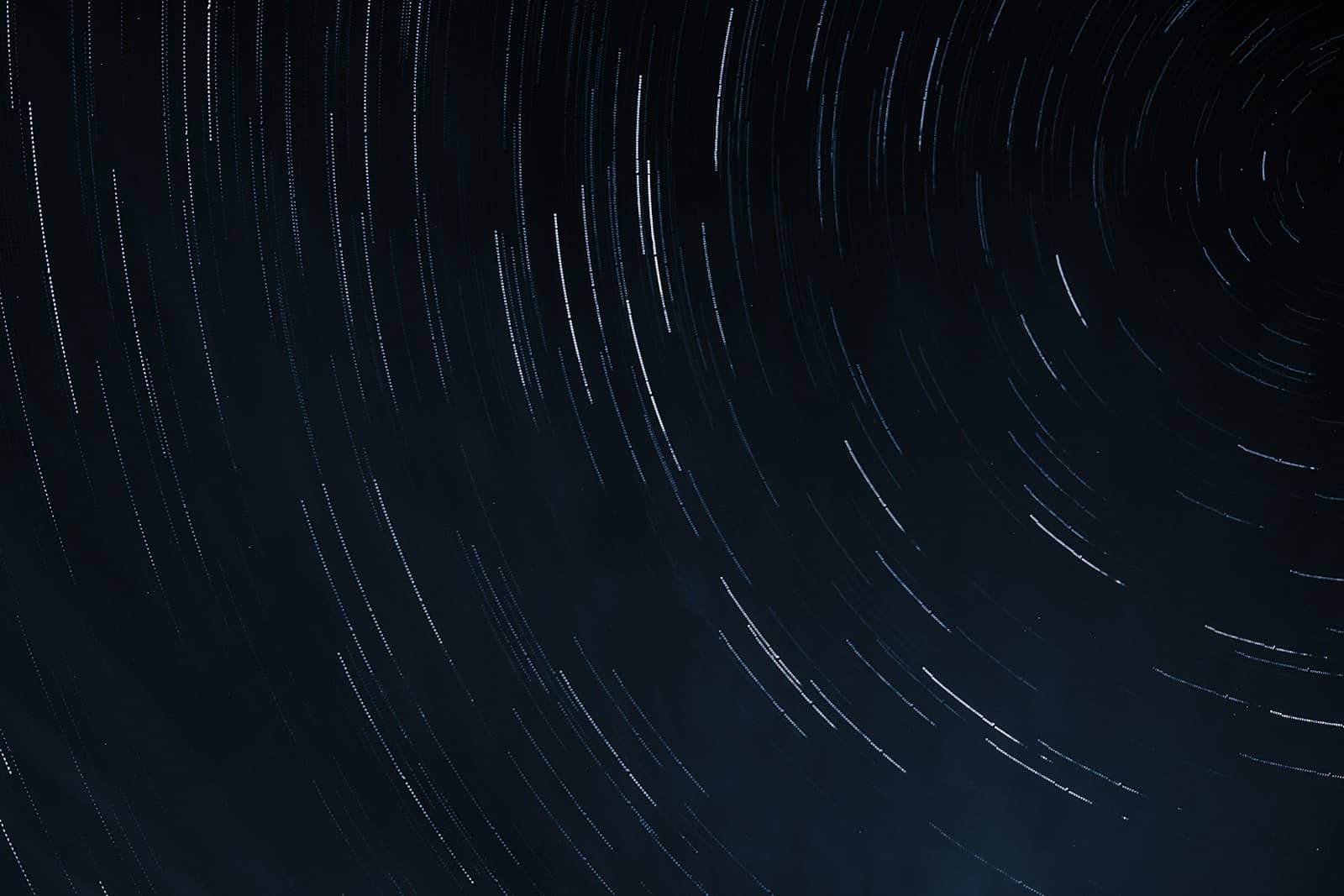 Abstract flowing particles of light on a dark background