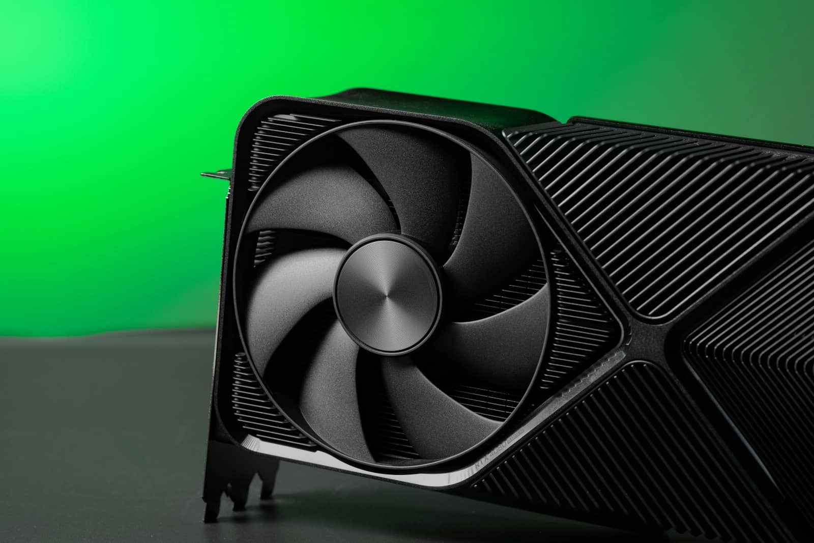 A sleek NVIDIA RTX graphics card against a green background
