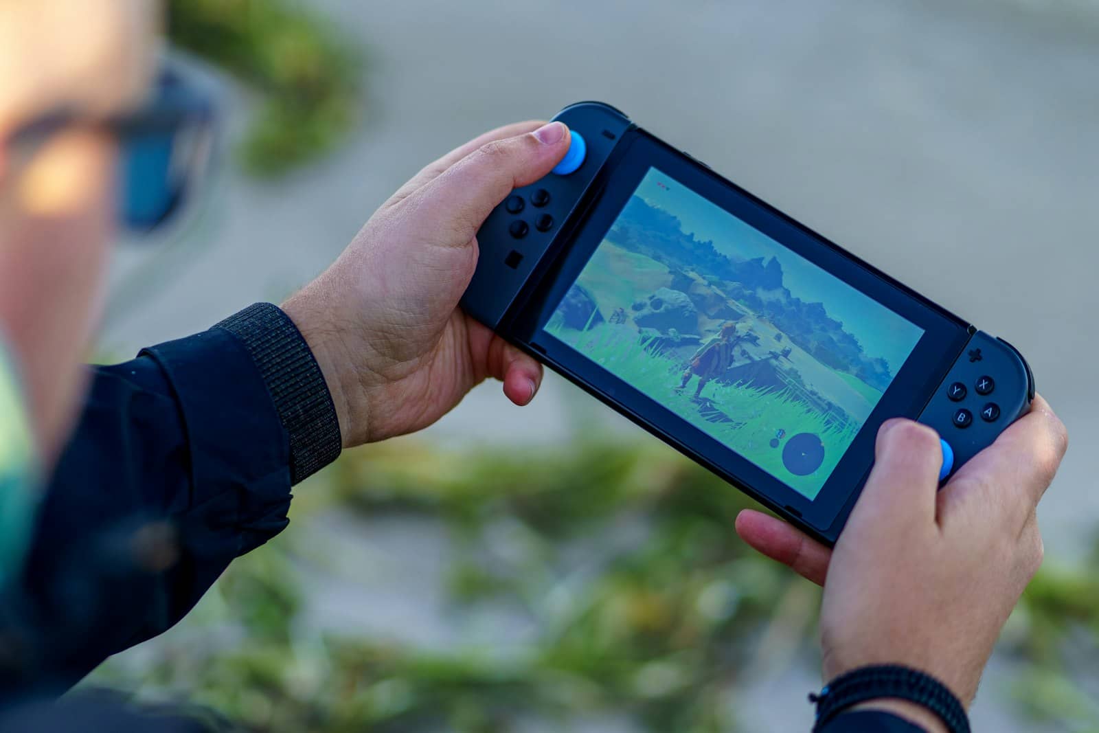 A person playing a game on a handheld console