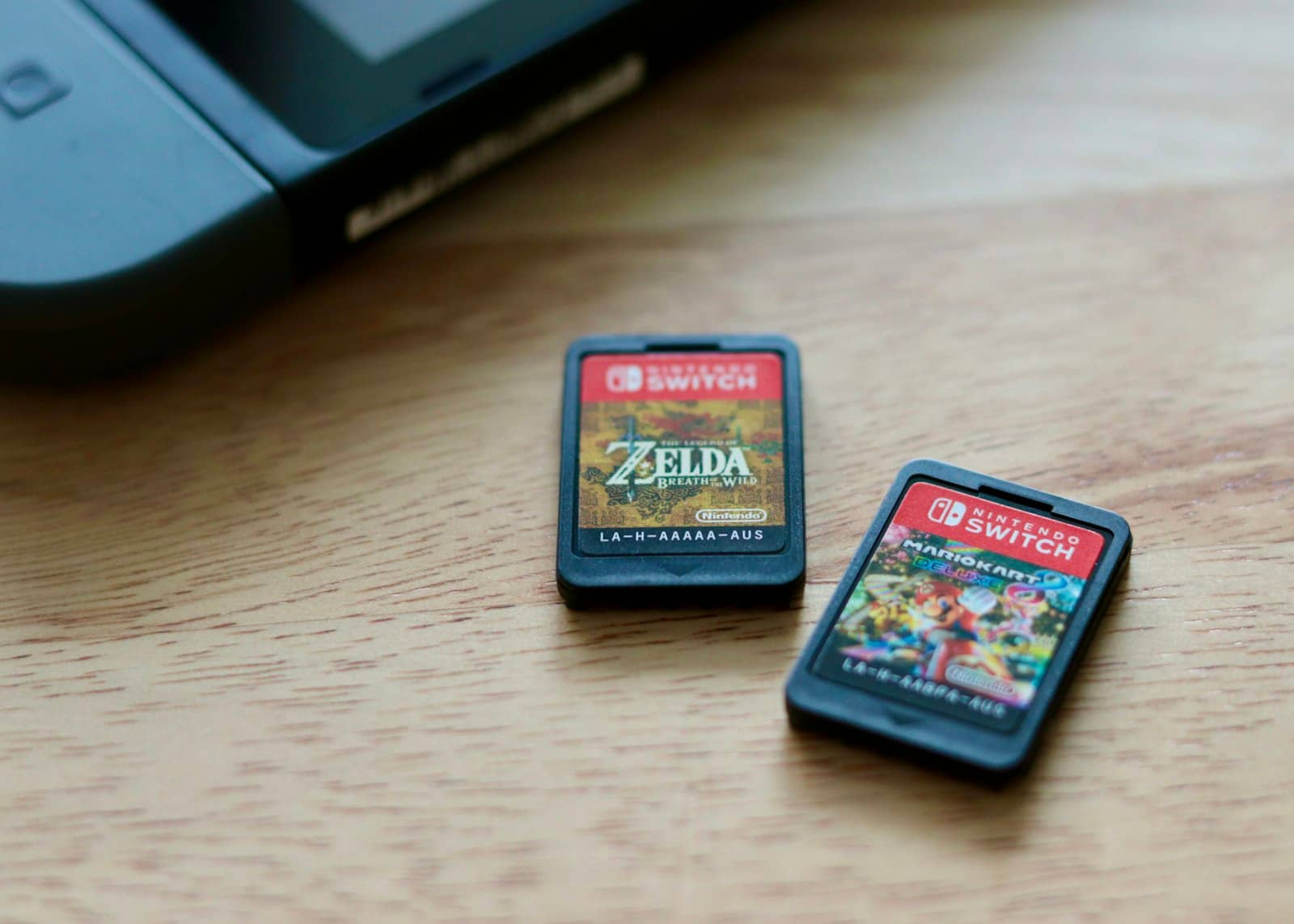 Physical Nintendo Switch game cartridges next to a console