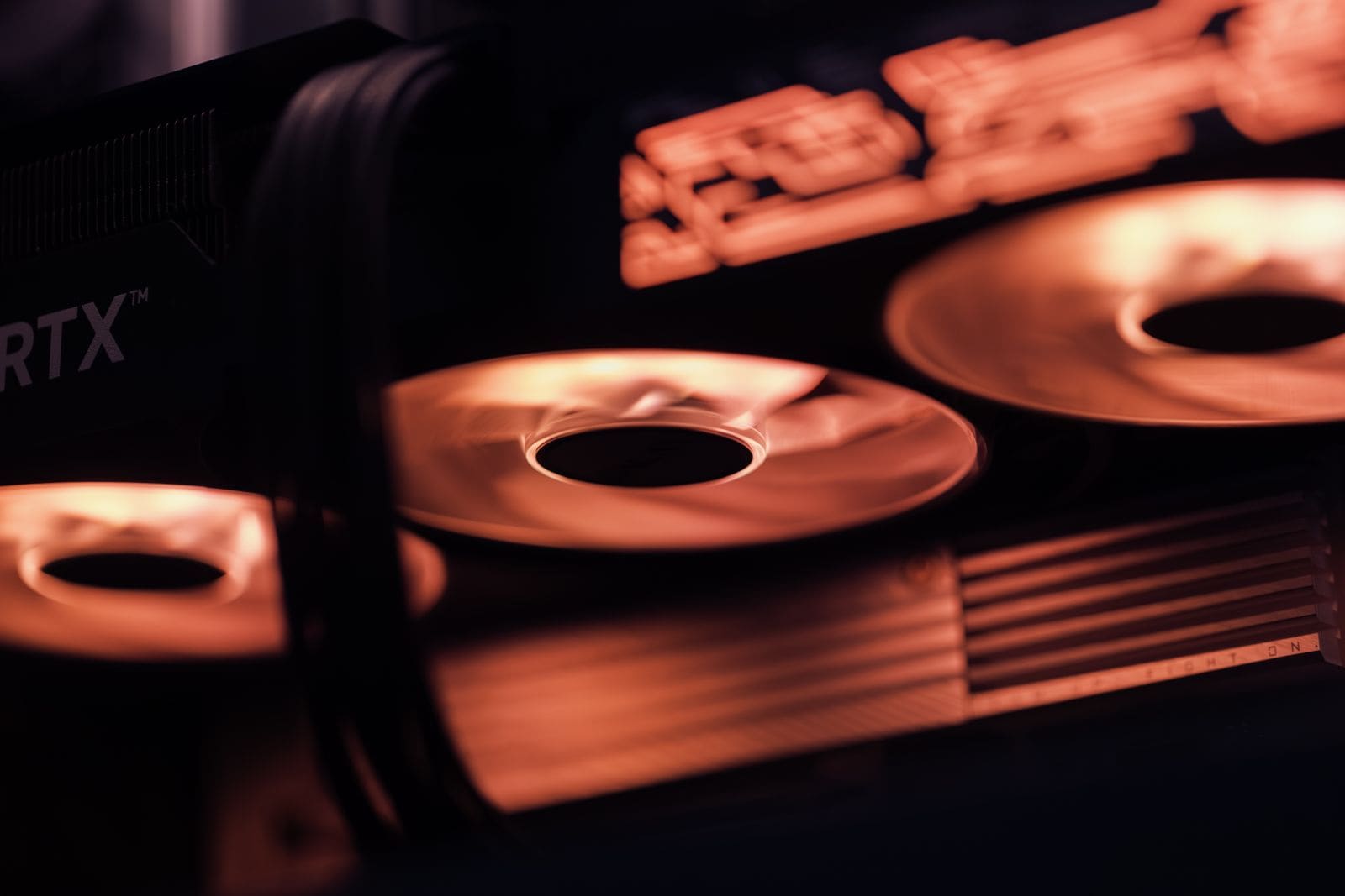 Graphics card cooling fans lit in red inside a PC build