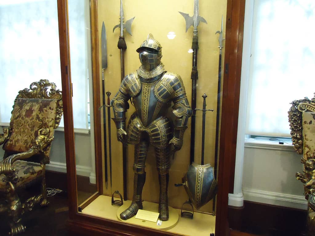 A knight in armor competing in a medieval jousting tournament