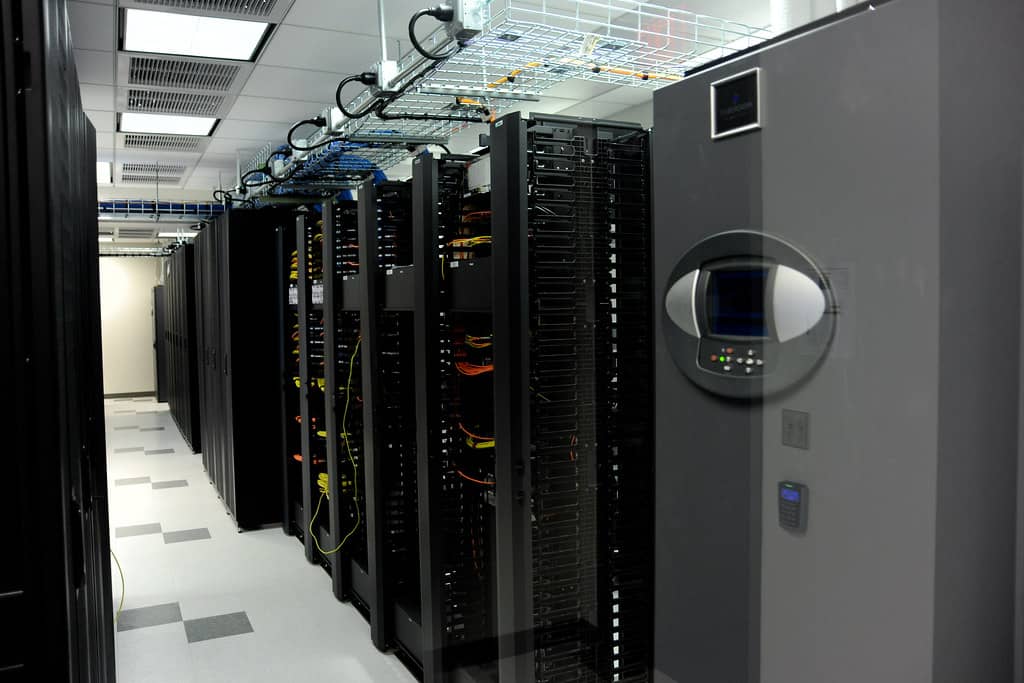 Rows of server racks in a data center, the kind of infrastructure a self-hosted Gitea instance typically runs on