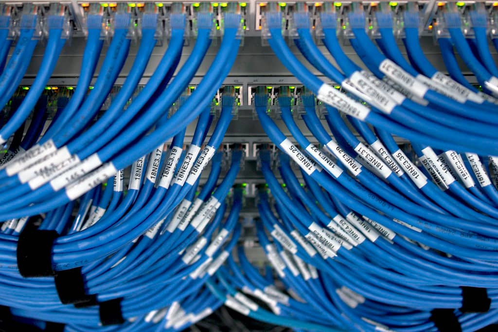 Networking equipment in a server rack, illustrating the enterprise and prosumer infrastructure UniFi OS runs on
