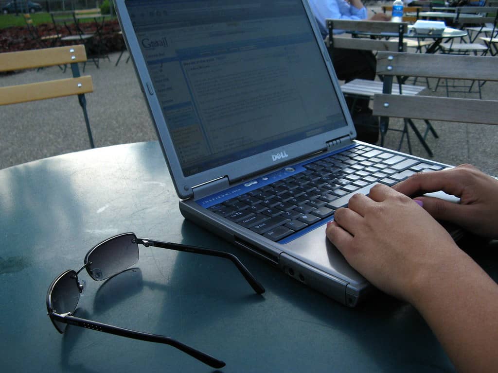 Laptop screen displaying an email inbox interface, representing a mail server under attack
