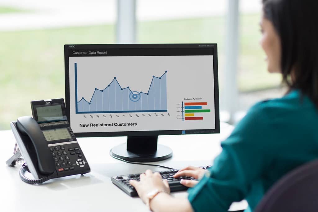 IT administrator monitoring multiple screens showing server and network status