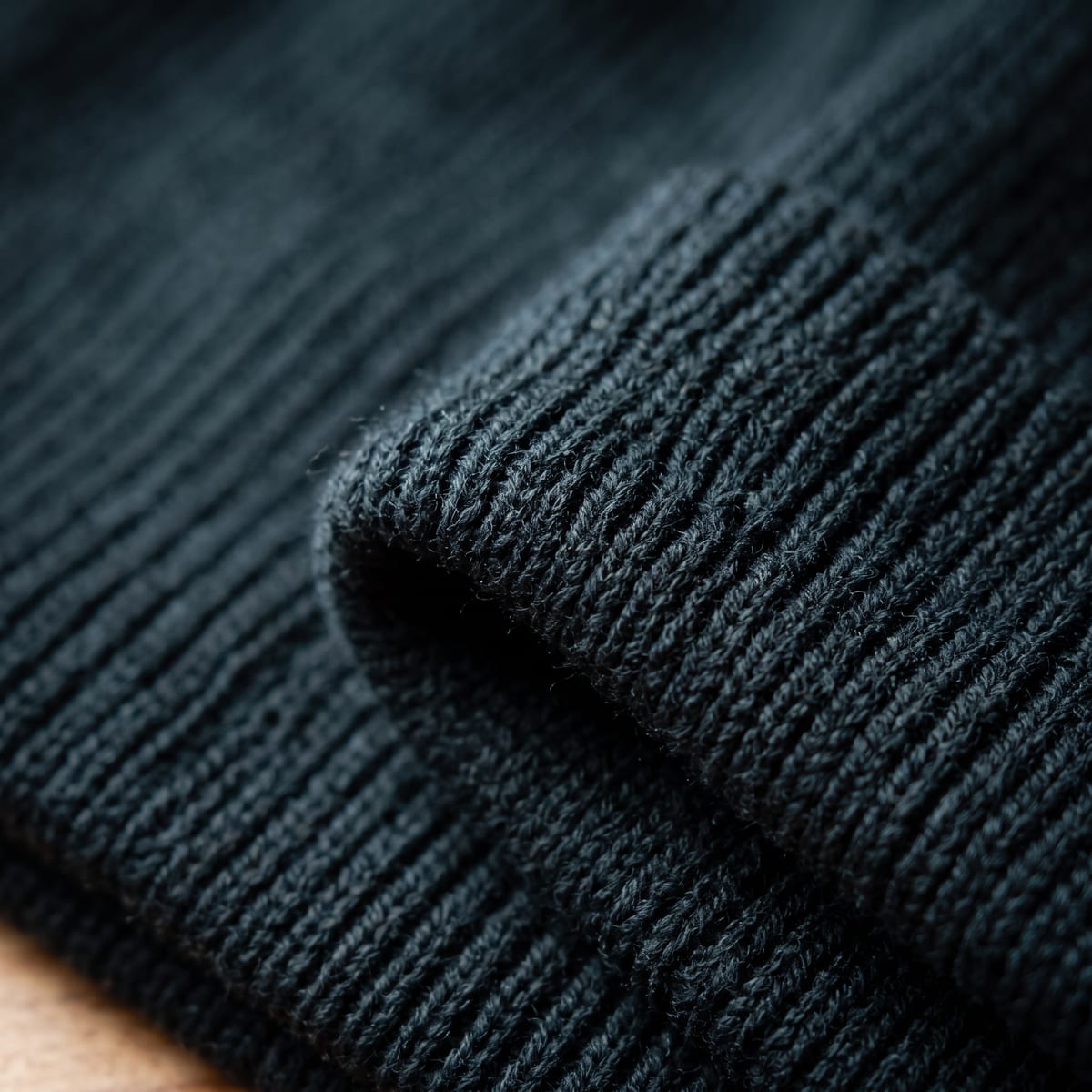 AI extreme close-up of chunky ribbed knit and a folded cuff edge