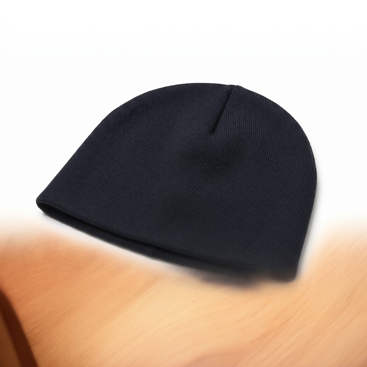 AI product shot of the uncuffed beanie where the bottom half of the white background shows blurred orange wood grain from the original photo