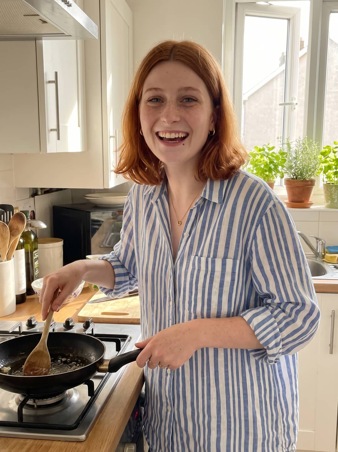 AI photo of the woman laughing while stirring a pan in a bright kitchen, wearing a blue and white striped shirt