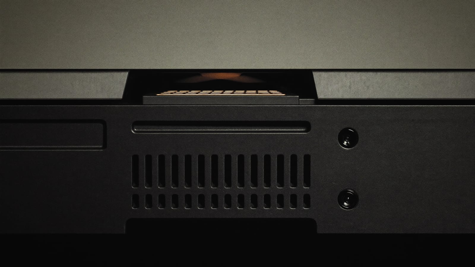 Close-up of a gaming laptop's rear exhaust vents and hinge