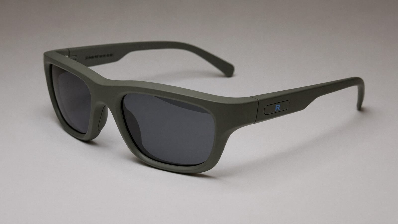 A pair of modern AR smart glasses resting on a clean surface