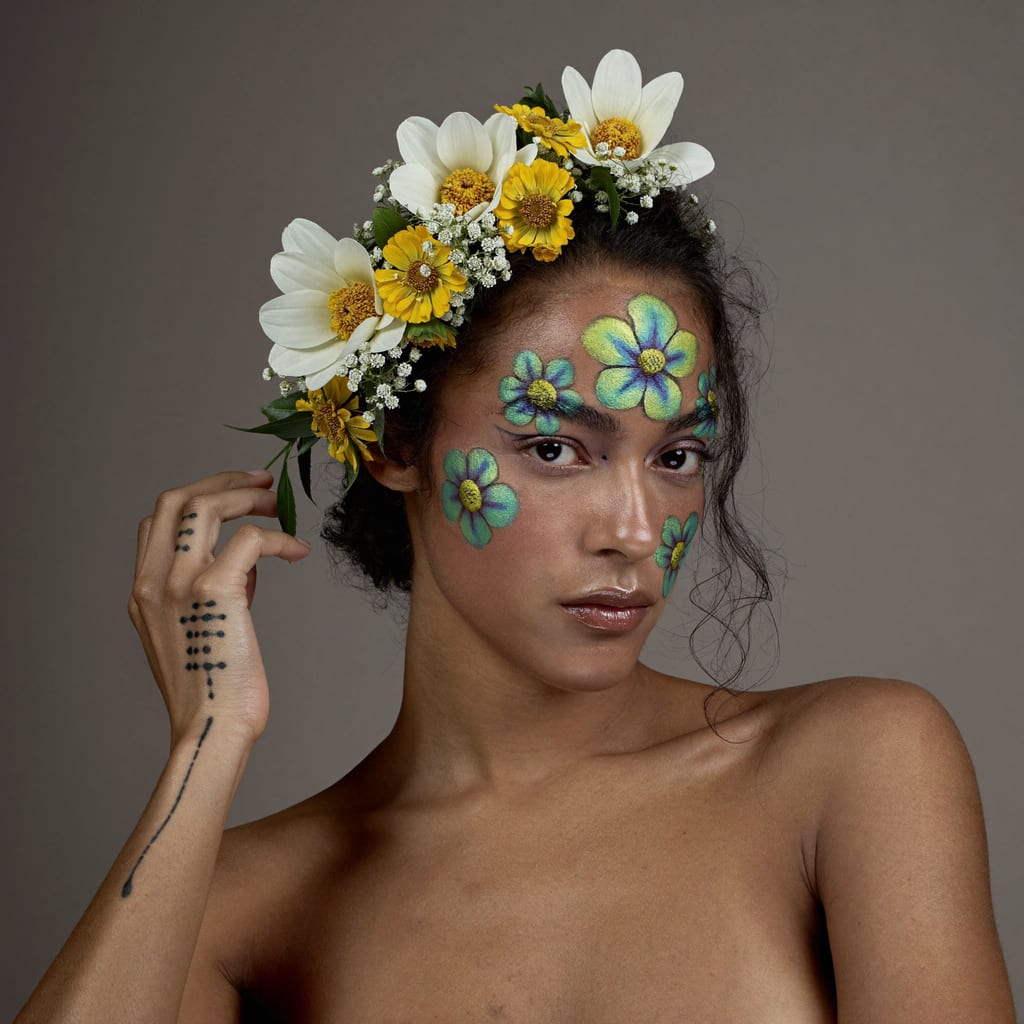 A beauty portrait with floral face paint generated with Higgsfield