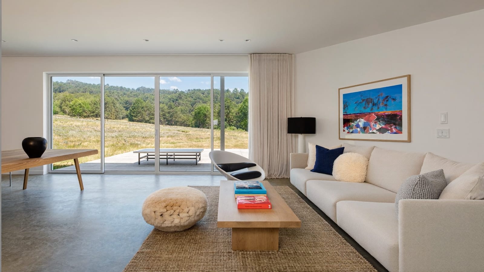 A bright, modern living room styled and lit for a real-estate listing photo