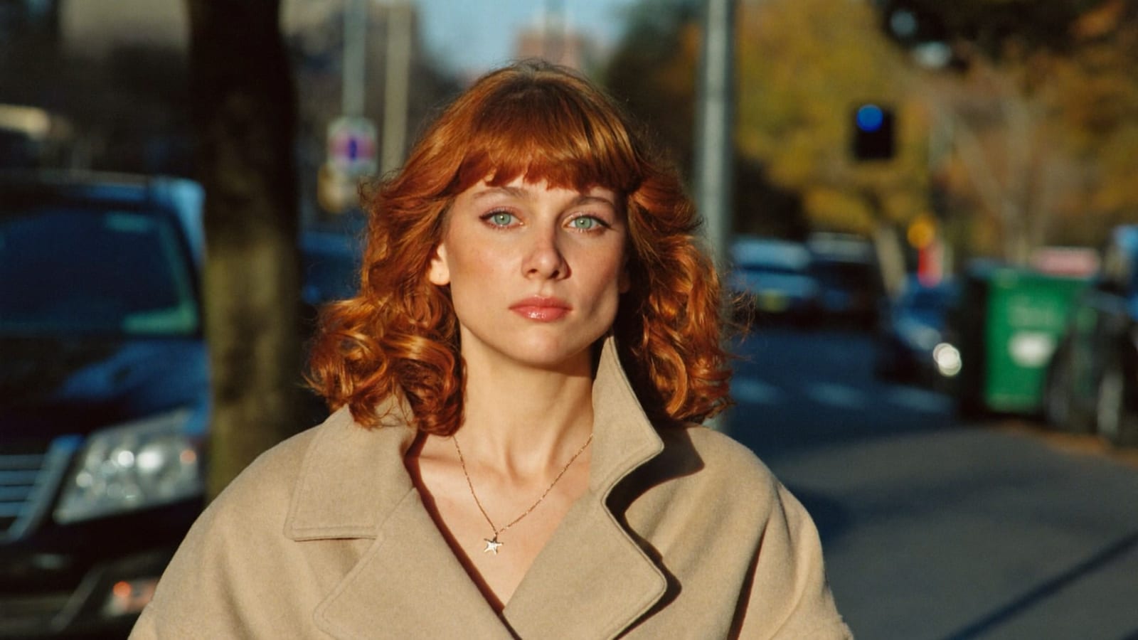 The same AI-generated character walking down an autumn city street, demonstrating identity consistency