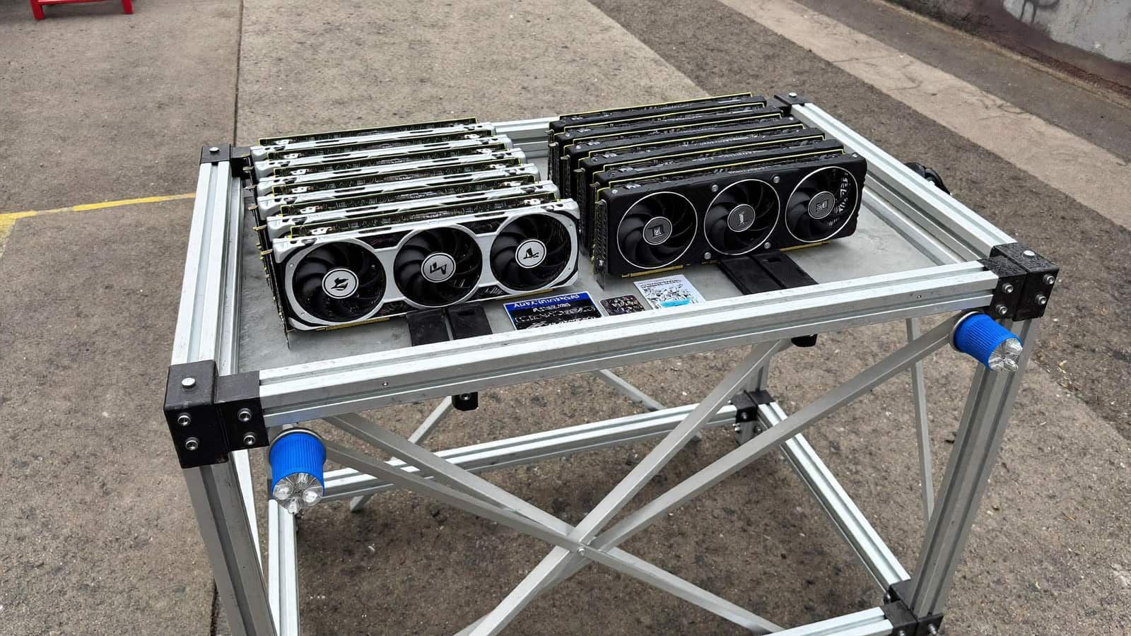 A large open-air test bench holding two graphics cards with visible power cables