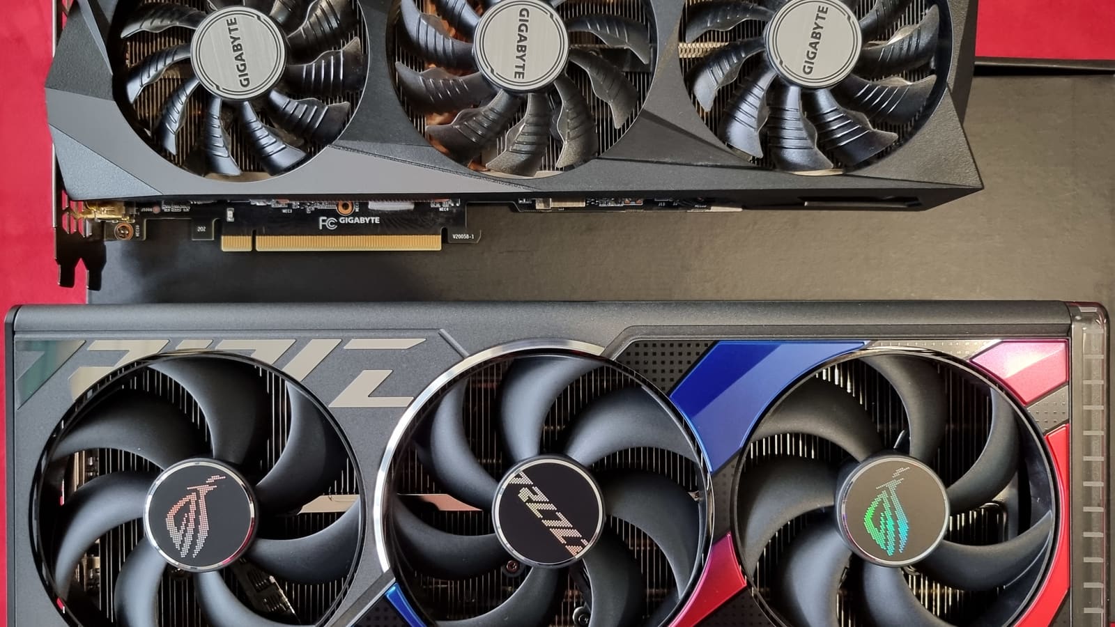 An NVIDIA RTX 3090 and RTX 4090 graphics card side by side, showing the size difference