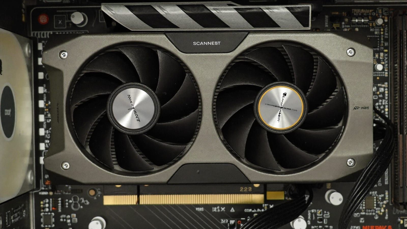 A compact modern dual-fan RTX 5060 Ti-class graphics card on a desk